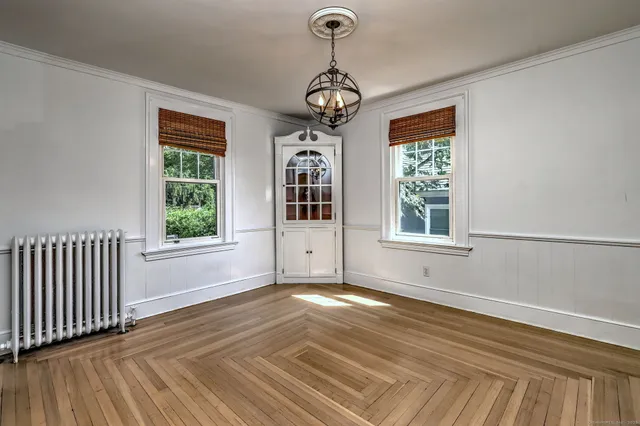 a view of a room with wooden floor windows and a chandelier