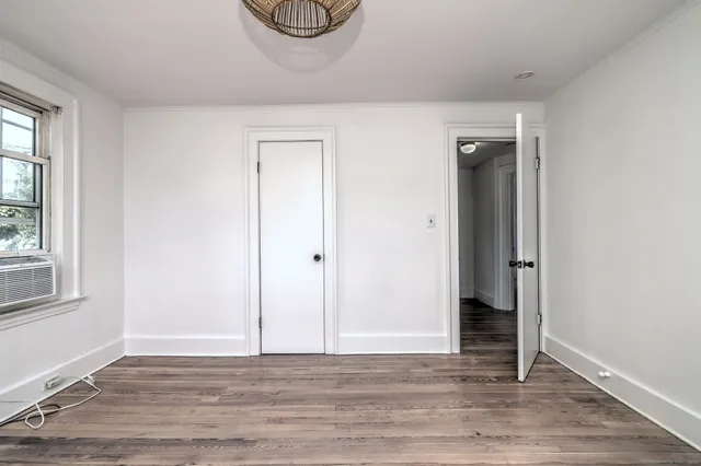 a view of a livingroom with wooden floor and a window
