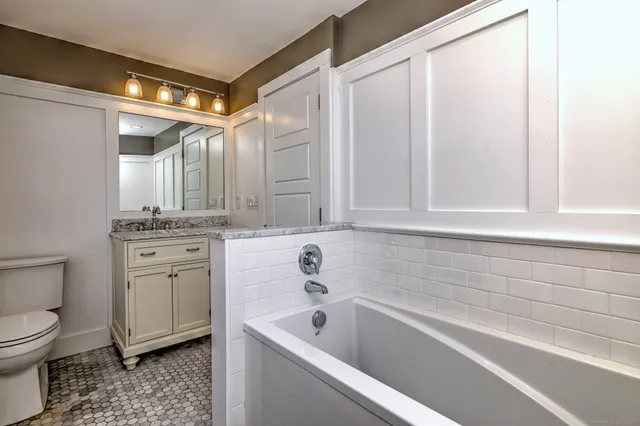 a bathroom with a sink a toilet and bathtub