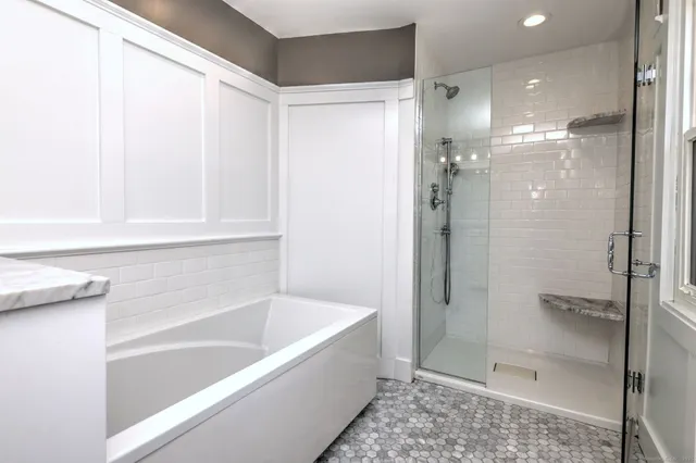 a bathroom with a bathtub and a shower