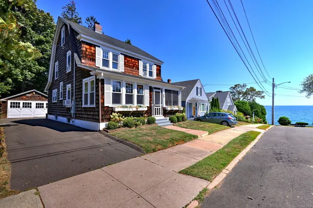 a front view of a house with a yard and table and chairs