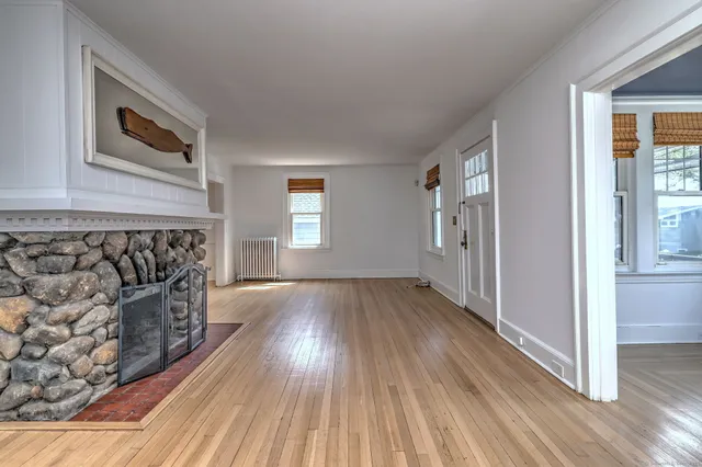 a view of a livingroom with wooden floor and staircase