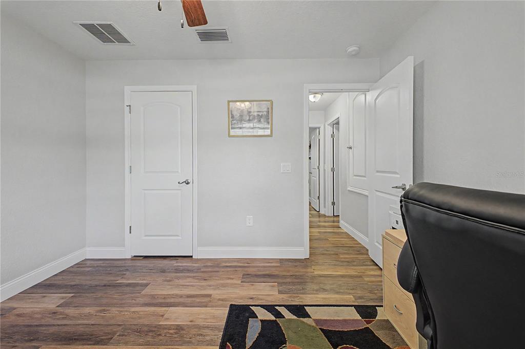 11213 Flock Avenue Weeki Wachee, FL 34613 - Photo 19 of 46 a view of a hallway with wooden floor and staircase