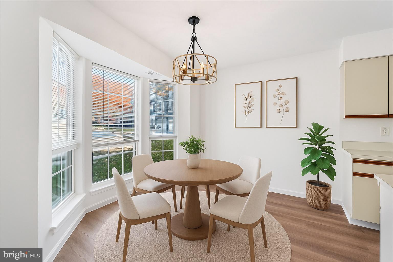 986 Breakwater Drive Annapolis, MD 21403 - Photo 2 of 31 a dining room with furniture potted plants and wooden floor