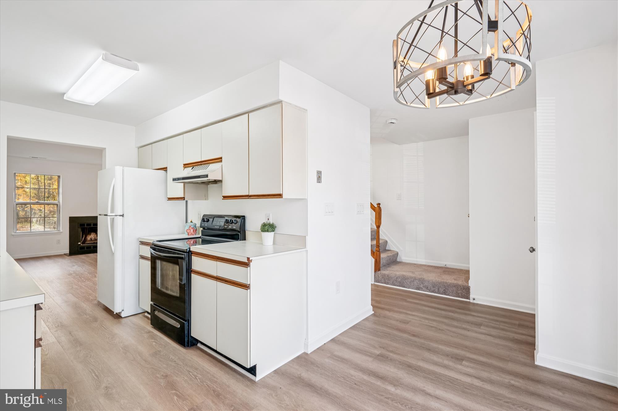 986 Breakwater Drive Annapolis, MD 21403 - Photo 4 of 31 a kitchen with stainless steel appliances a stove top oven a refrigerator a chimney and a wooden floor