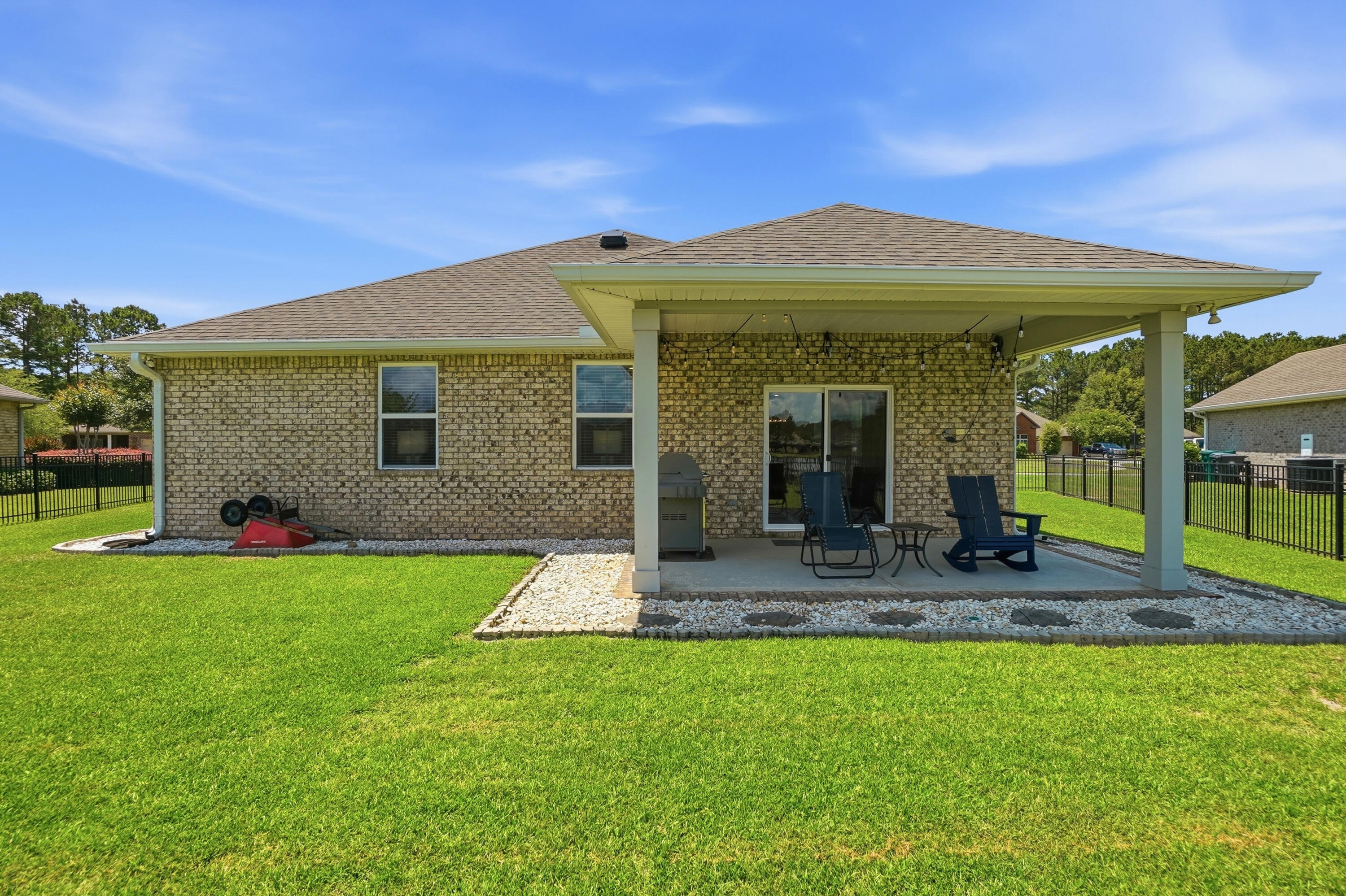 525 Windchime Way Freeport, FL 32439 - Photo 35 of 59 a front view of a house with swimming pool and porch