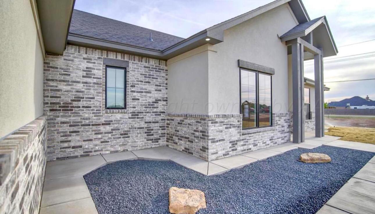 a bathroom with a granite countertop sink a toilet and mirror