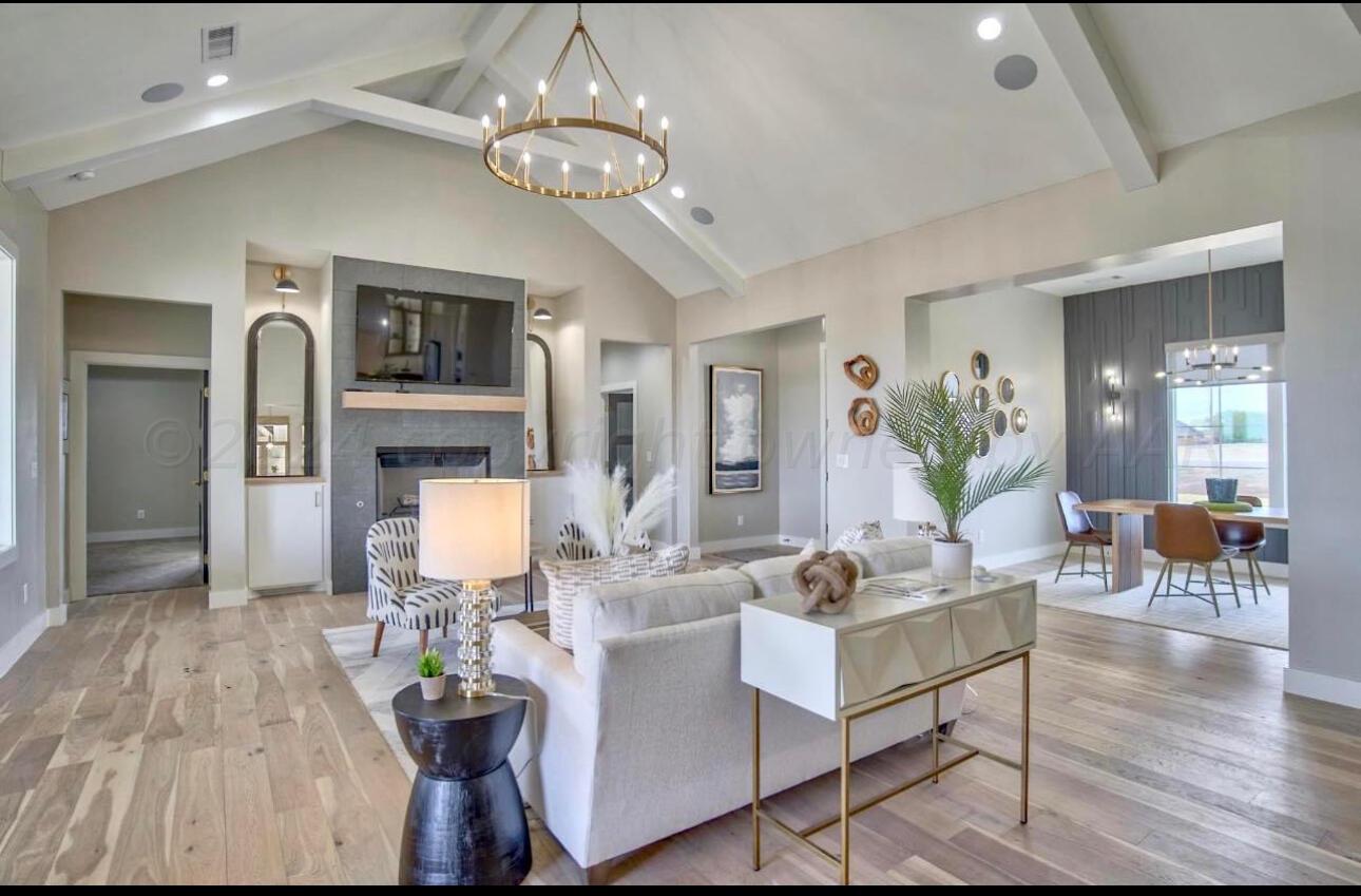 19181 Buck Springs Road Amarillo, TX 79119 - Photo 13 of 86 a living room with furniture and a chandelier