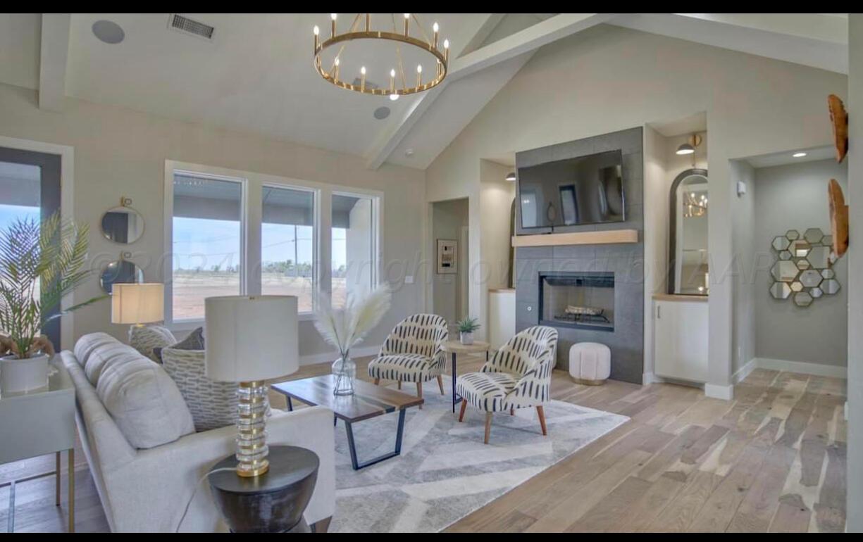 19181 Buck Springs Road Amarillo, TX 79119 - Photo 16 of 86 a living room with furniture chandelier and a fireplace