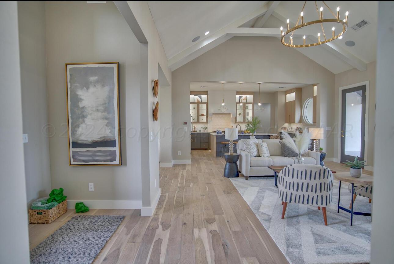 19181 Buck Springs Road Amarillo, TX 79119 - Photo 18 of 86 a living room with furniture and a chandelier