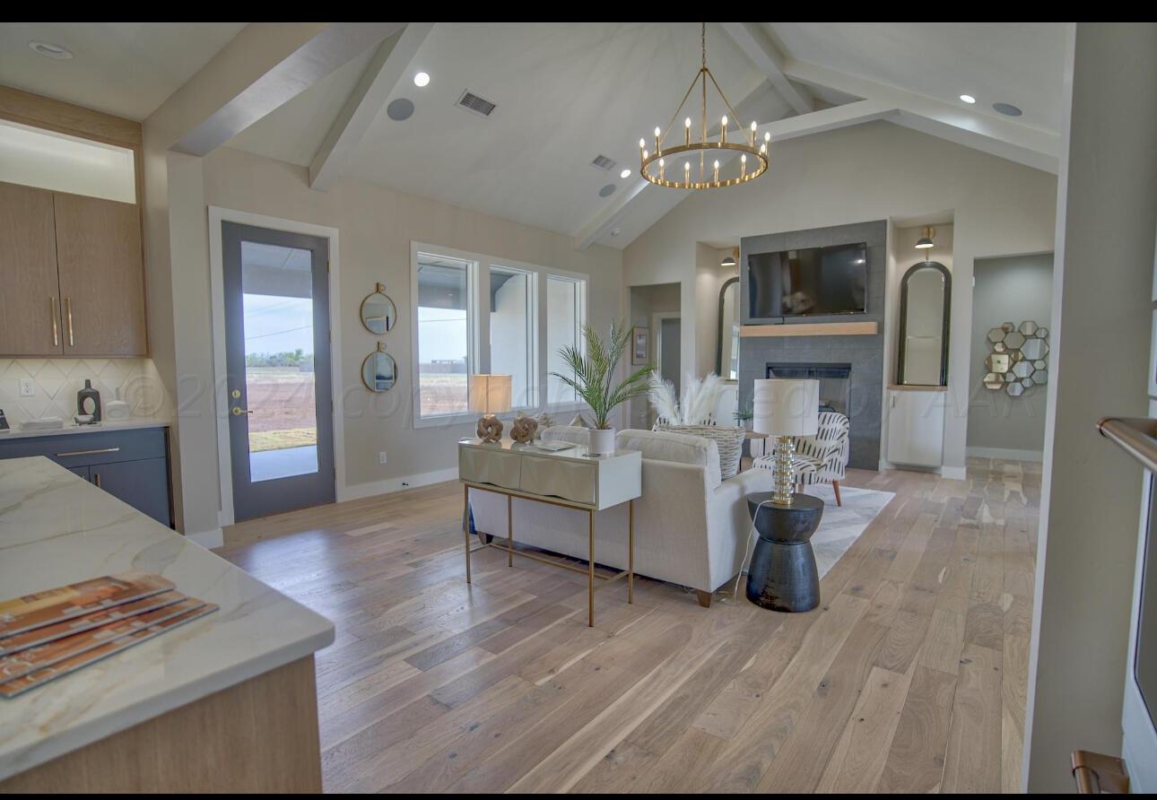 19181 Buck Springs Road Amarillo, TX 79119 - Photo 21 of 86 a living room with furniture and a chandelier