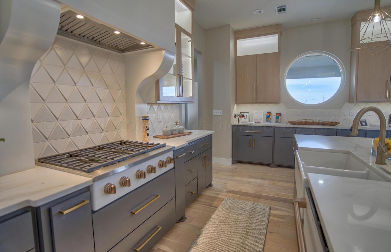 19181 Buck Springs Road Amarillo, TX 79119 - Photo 28 of 86 a kitchen with sink stove and cabinets