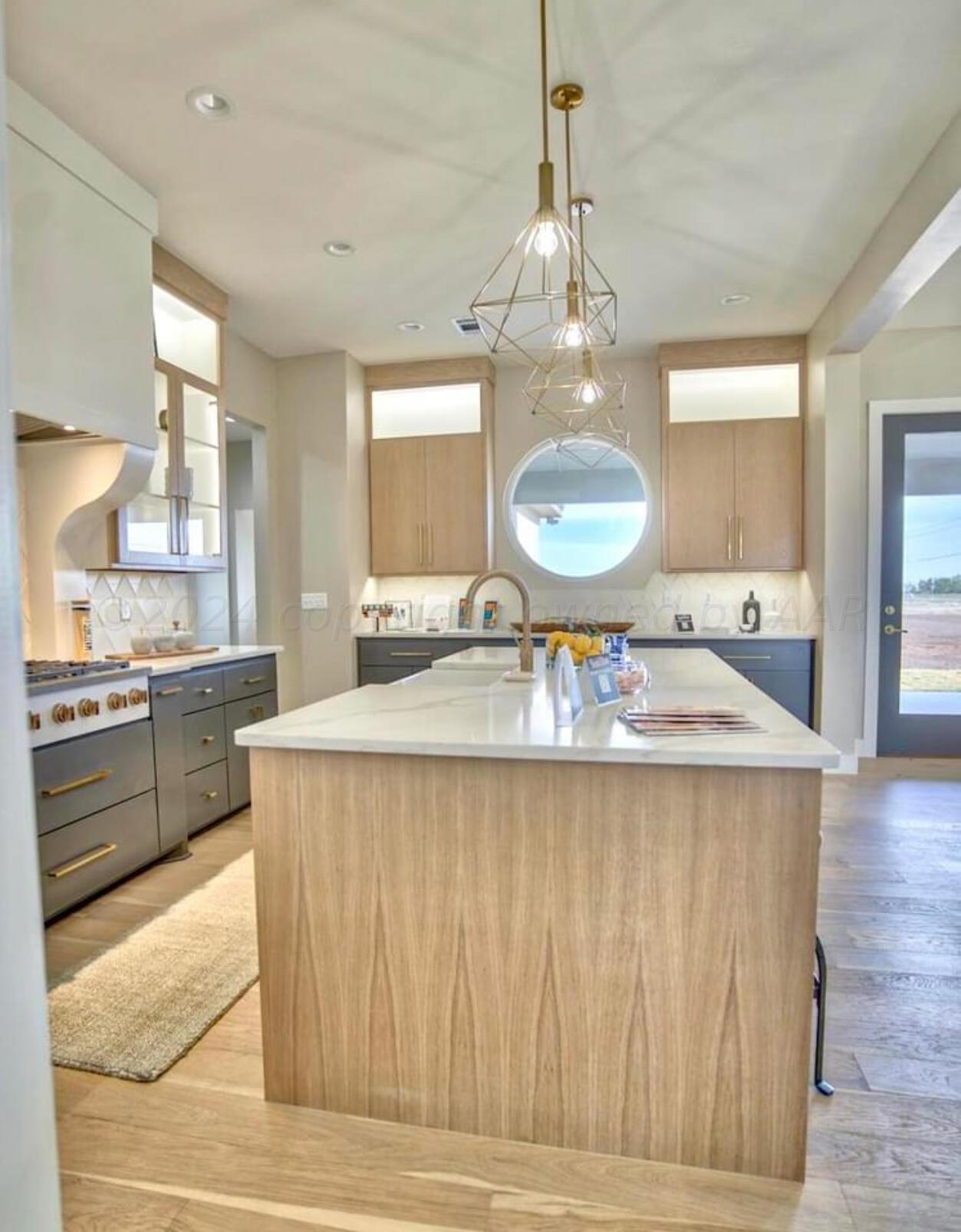 19181 Buck Springs Road Amarillo, TX 79119 - Photo 31 of 86 a large kitchen with kitchen island a sink stainless steel appliances and cabinets