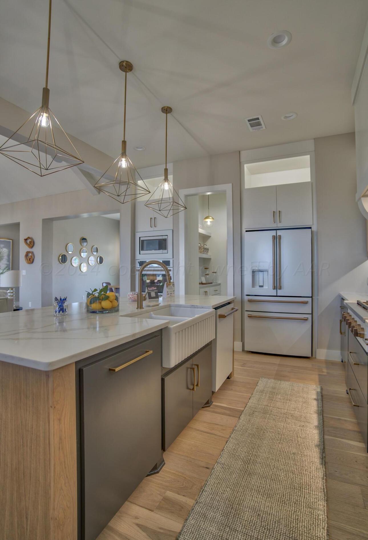19181 Buck Springs Road Amarillo, TX 79119 - Photo 33 of 86 a kitchen with kitchen island a sink a counter space appliances and cabinets