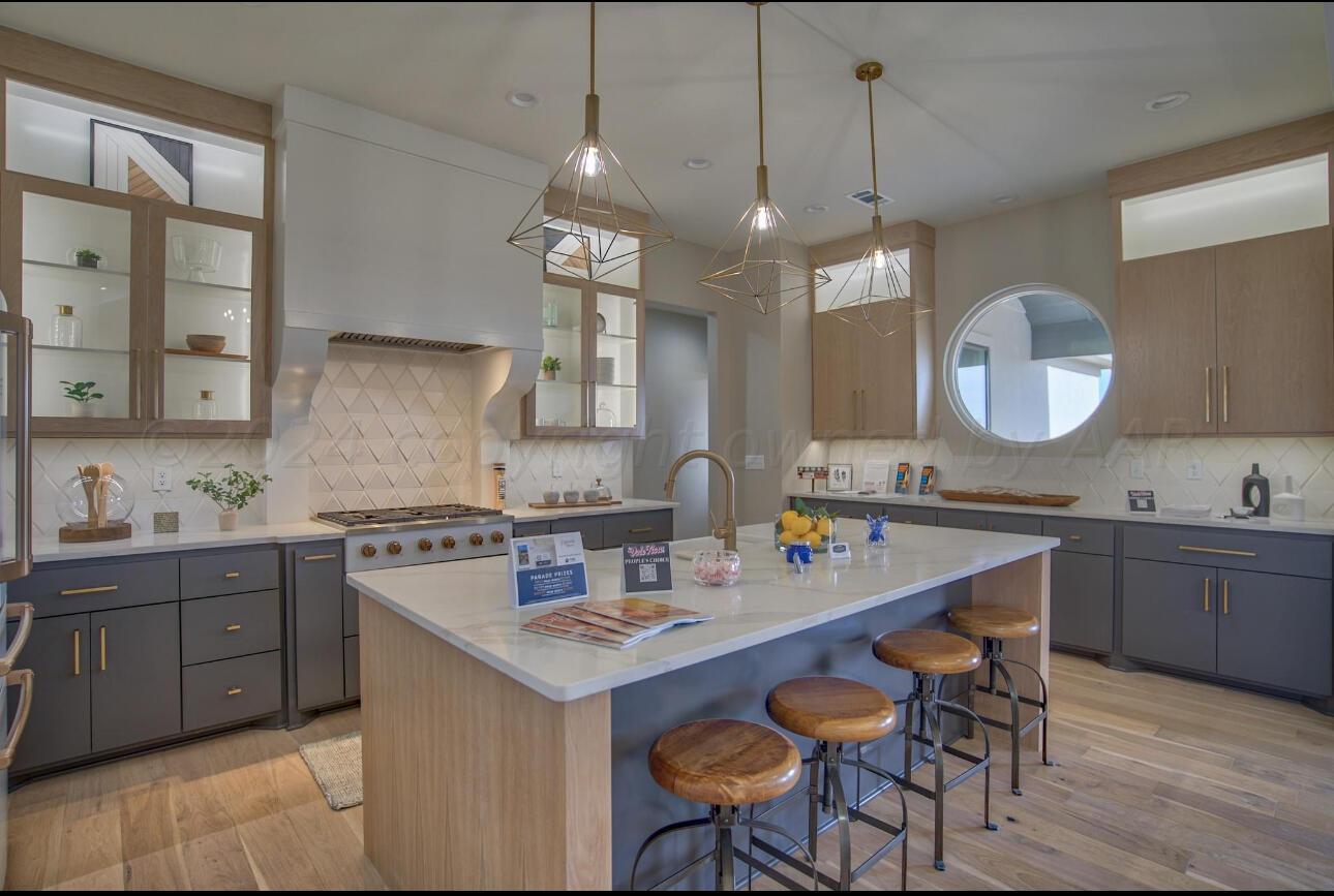 19181 Buck Springs Road Amarillo, TX 79119 - Photo 38 of 86 a kitchen with a sink stove and wooden floor