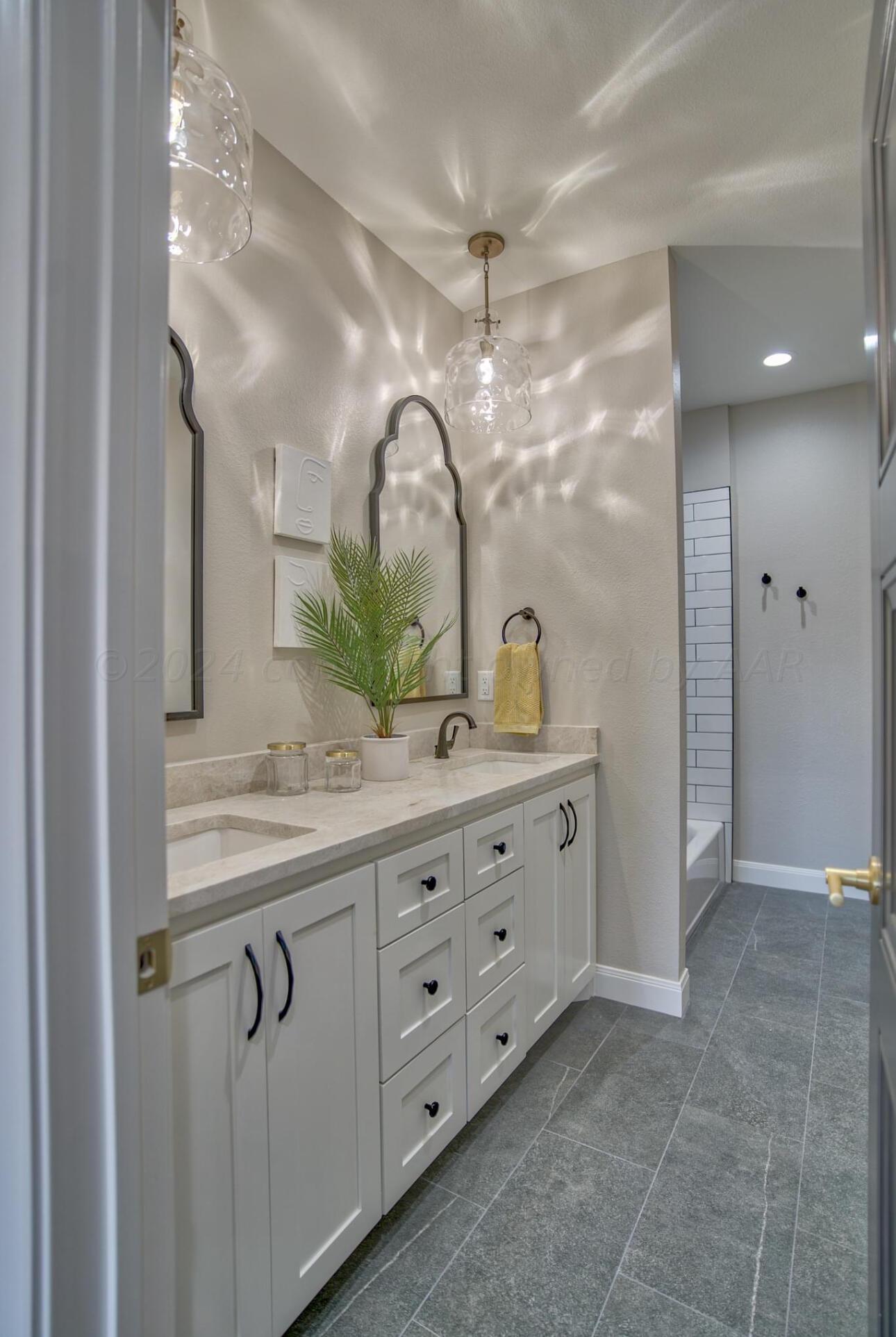19181 Buck Springs Road Amarillo, TX 79119 - Photo 61 of 86 a bathroom with a granite countertop sink a mirror and a shower