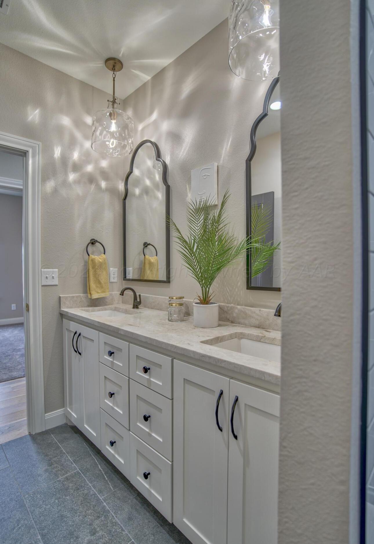 19181 Buck Springs Road Amarillo, TX 79119 - Photo 62 of 86 a bathroom with a double vanity sink and a mirror