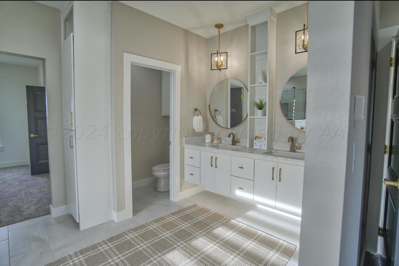19181 Buck Springs Road Amarillo, TX 79119 - Photo 66 of 86 a spacious bathroom with a granite countertop sink mirror and a toilet
