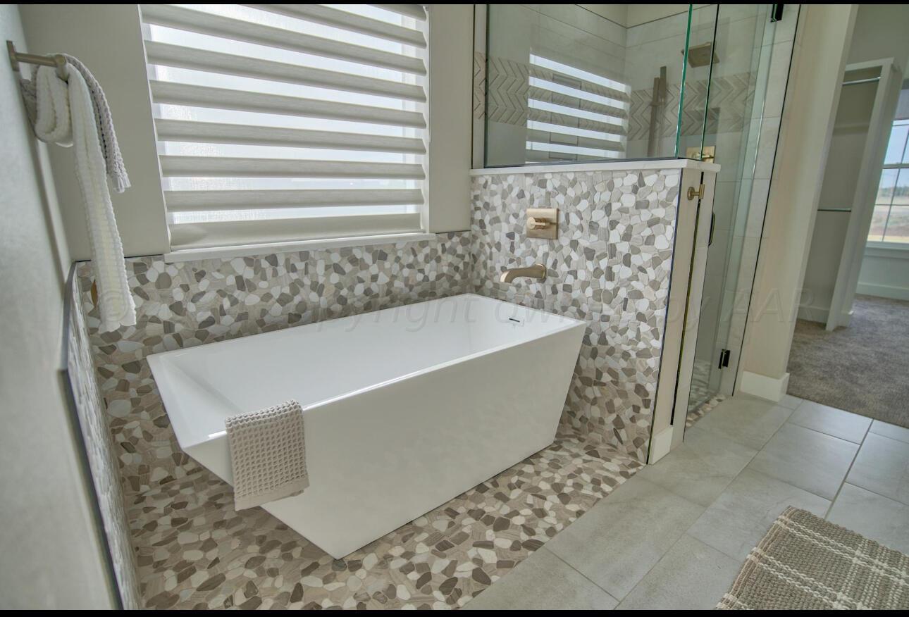 19181 Buck Springs Road Amarillo, TX 79119 - Photo 69 of 86 a bath tub sitting in a bathroom next to a sink