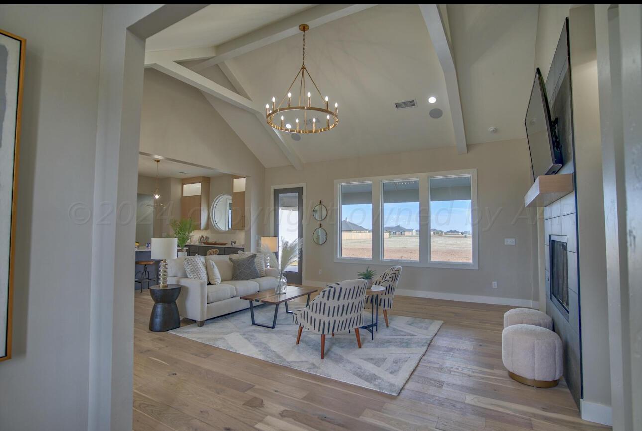 19181 Buck Springs Road Amarillo, TX 79119 - Photo 10 of 86 a living room with furniture and a chandelier