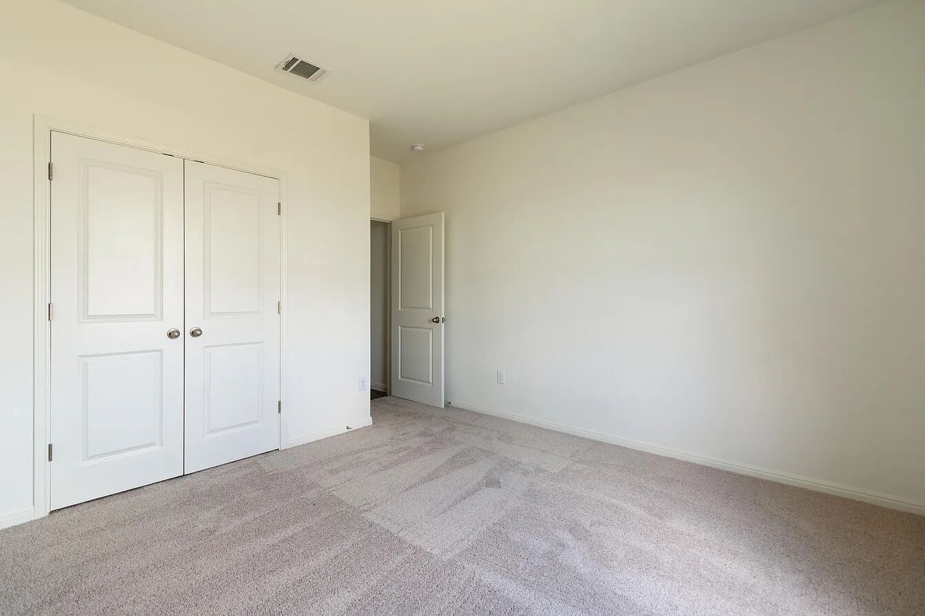101 Aoudad Road Hutto, TX 78634 - Photo 20 of 39 A well-maintained carpeted floor and crisp walls define this comfortable bedroom space.