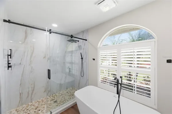 a bathroom with a granite countertop sink mirror vanity and toilet
