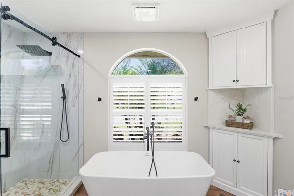 a bathroom with a bathtub and a shower