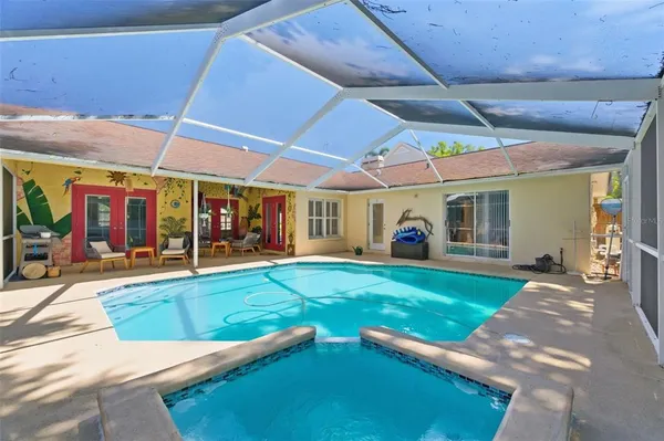 a view of a backyard with table and chairs under an umbrella