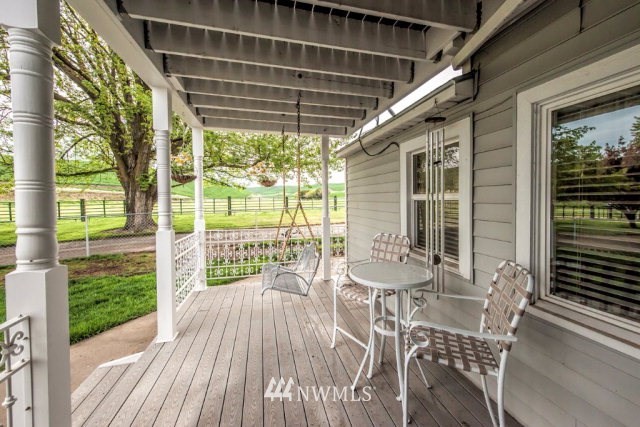 9590 Smith Springs Road Prescott, WA 99348 - Photo 19 of 40 a view of a patio with a table chairs and wooden floor