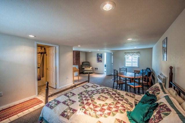 9590 Smith Springs Road Prescott, WA 99348 - Photo 22 of 40 a living room with furniture a rug and a flat screen tv