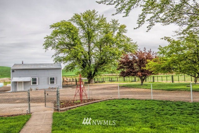 9590 Smith Springs Road Prescott, WA 99348 - Photo 38 of 40 a view of a house with a yard and tree s