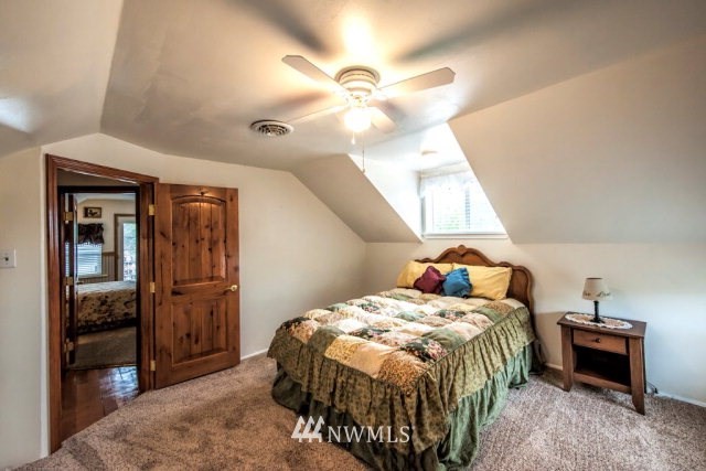 9590 Smith Springs Road Prescott, WA 99348 - Photo 7 of 40 a bedroom with a bed and a chandelier