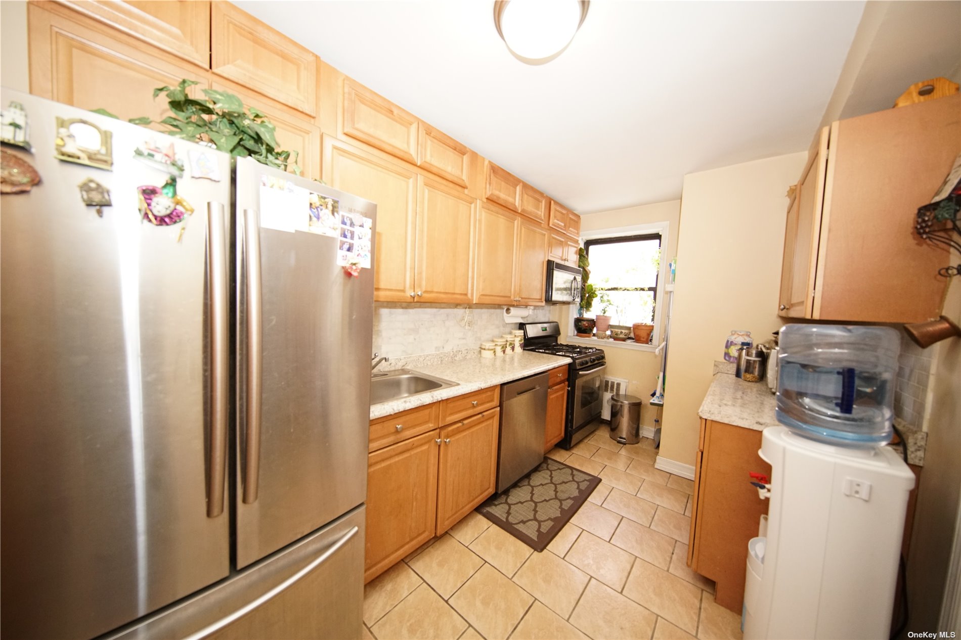 a kitchen with stainless steel appliances a refrigerator sink and cabinets
