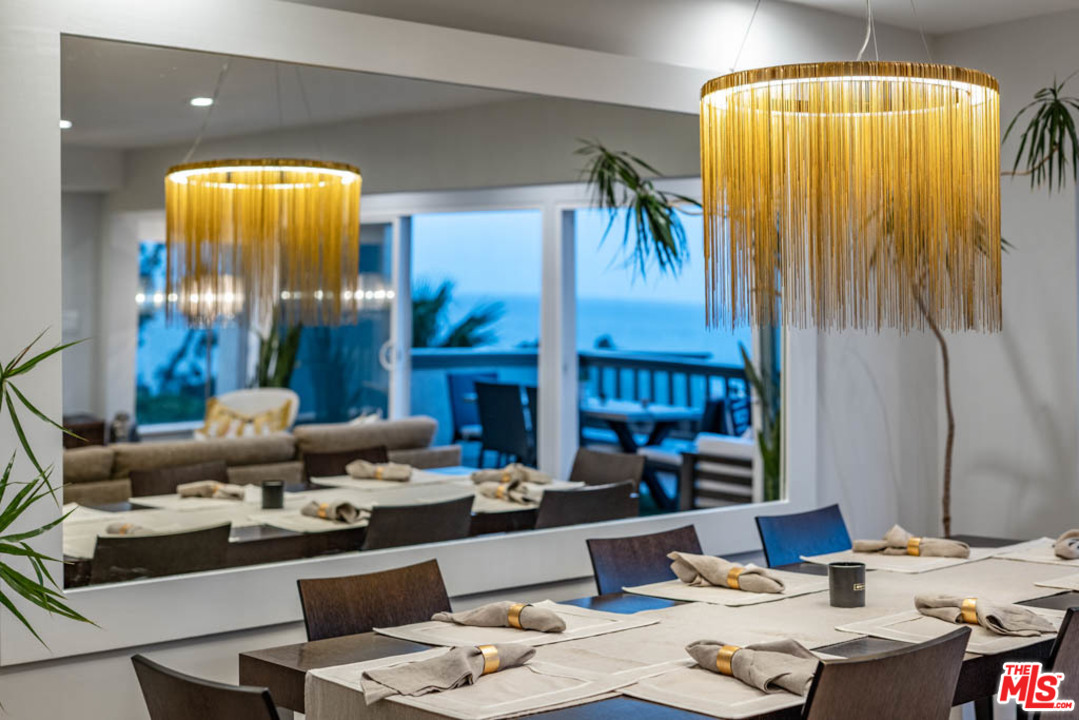 23910 De Way, Unit C Malibu, CA 90265 - Photo 14 of 45 a living room with fireplace furniture and a chandelier