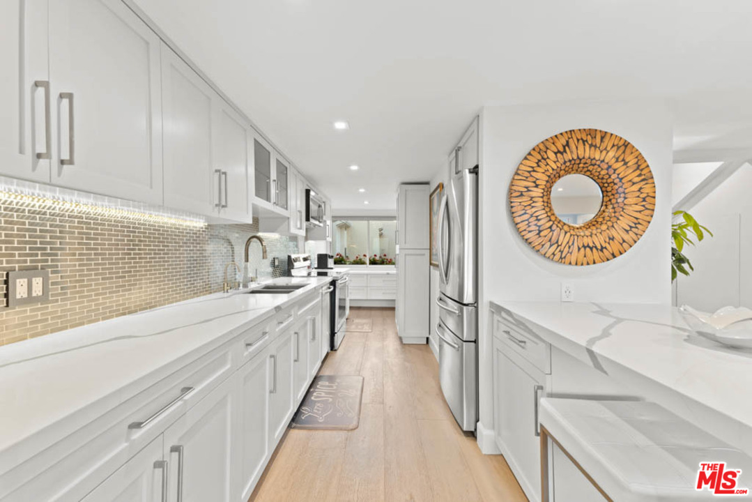 23910 De Way, Unit C Malibu, CA 90265 - Photo 20 of 45 a kitchen with cabinets and a wooden floors