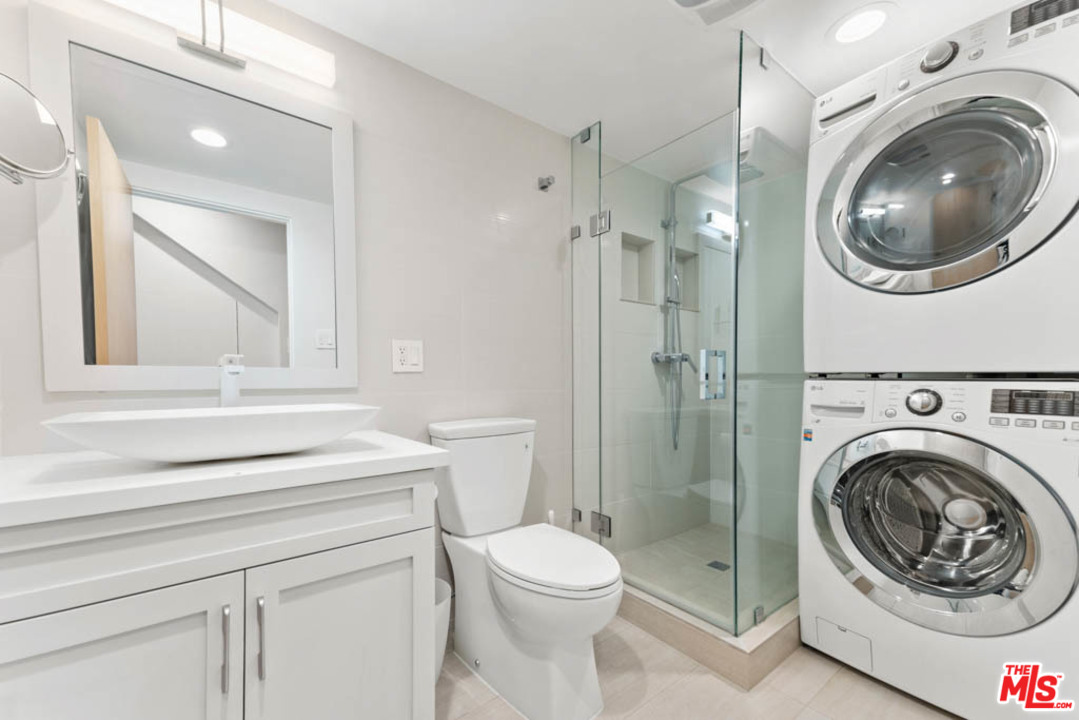 23910 De Way, Unit C Malibu, CA 90265 - Photo 27 of 45 a bathroom with a toilet sink a washer and dryer