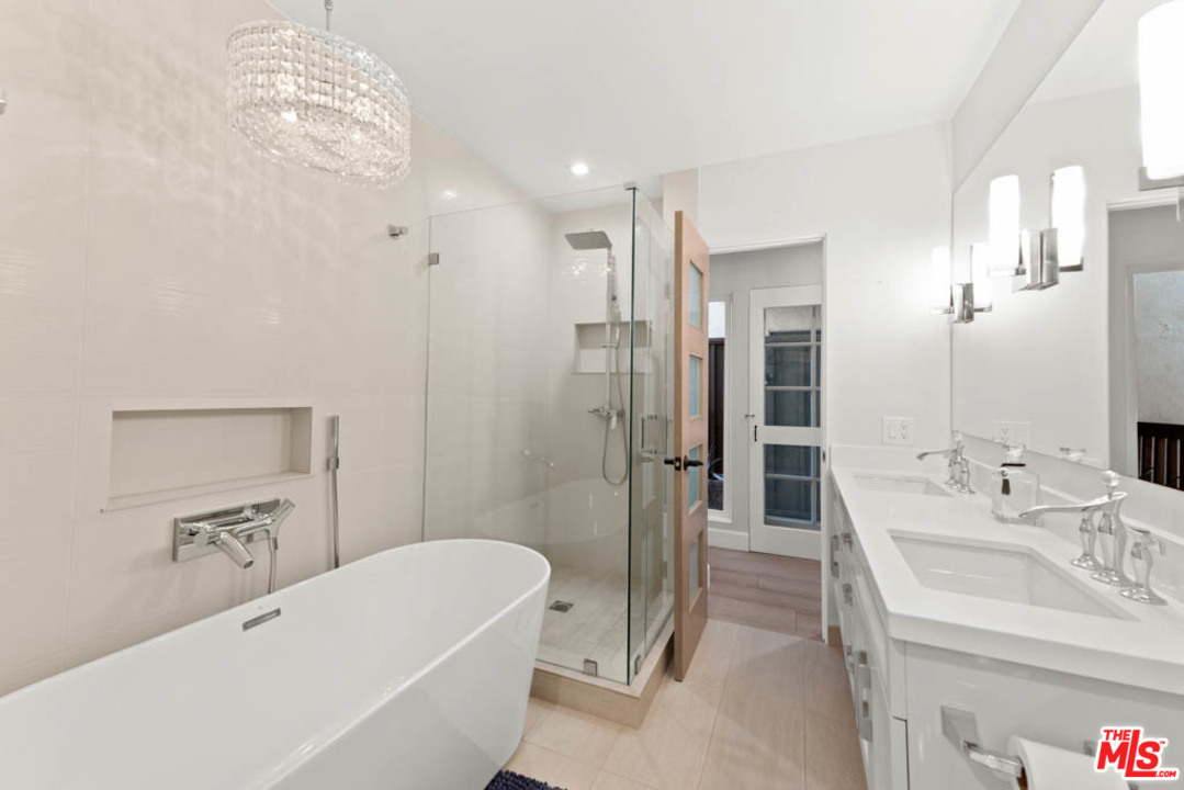 23910 De Way, Unit C Malibu, CA 90265 - Photo 30 of 45 a bathroom with a tub sink and mirror