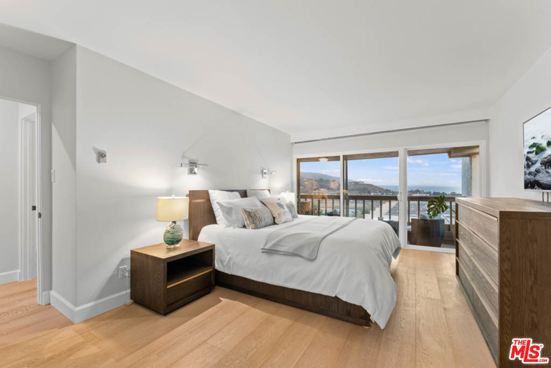 23910 De Way, Unit C Malibu, CA 90265 - Photo 33 of 45 a bedroom with a bed and large window