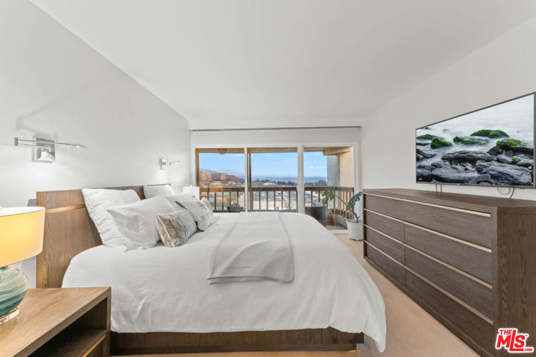 23910 De Way, Unit C Malibu, CA 90265 - Photo 34 of 45 a bedroom with a bed and a window