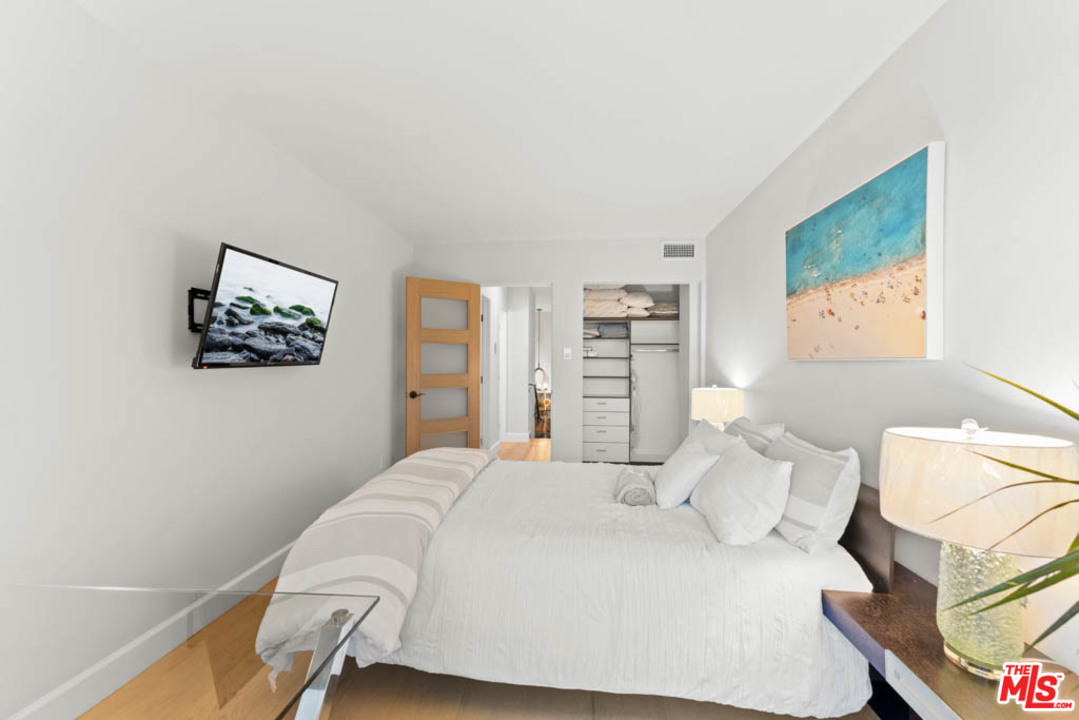 23910 De Way, Unit C Malibu, CA 90265 - Photo 38 of 45 a bedroom with a bed and a painting on the wall