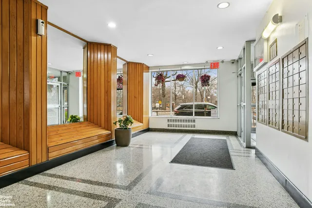 a view of front door with furniture and a balcony