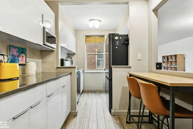 a living room with furniture a rug and a large window