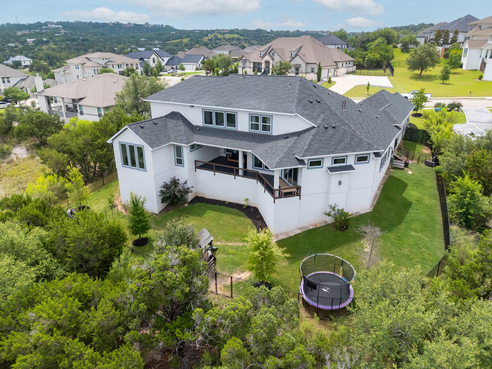 104 Lodestone Cove Austin, TX 78738 - Photo 35 of 40 A spacious hillside residence with a sprawling backyard and expansive decking for outdoor enjoyment.