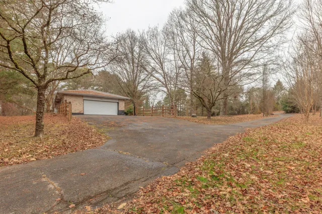 a backyard of a house with large trees