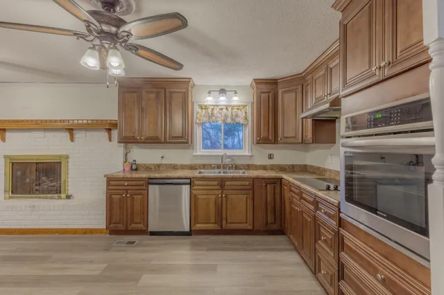 a view of a livingroom with wooden floor and an chairs