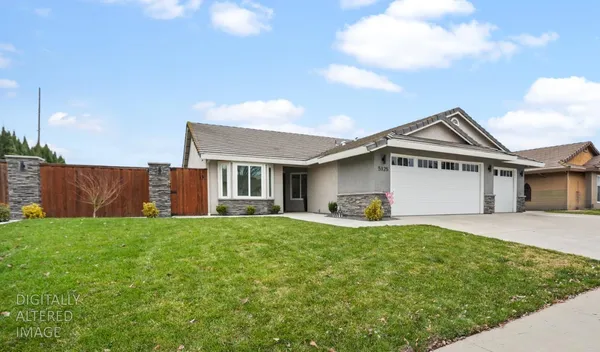 a view of a house with a yard and sitting area