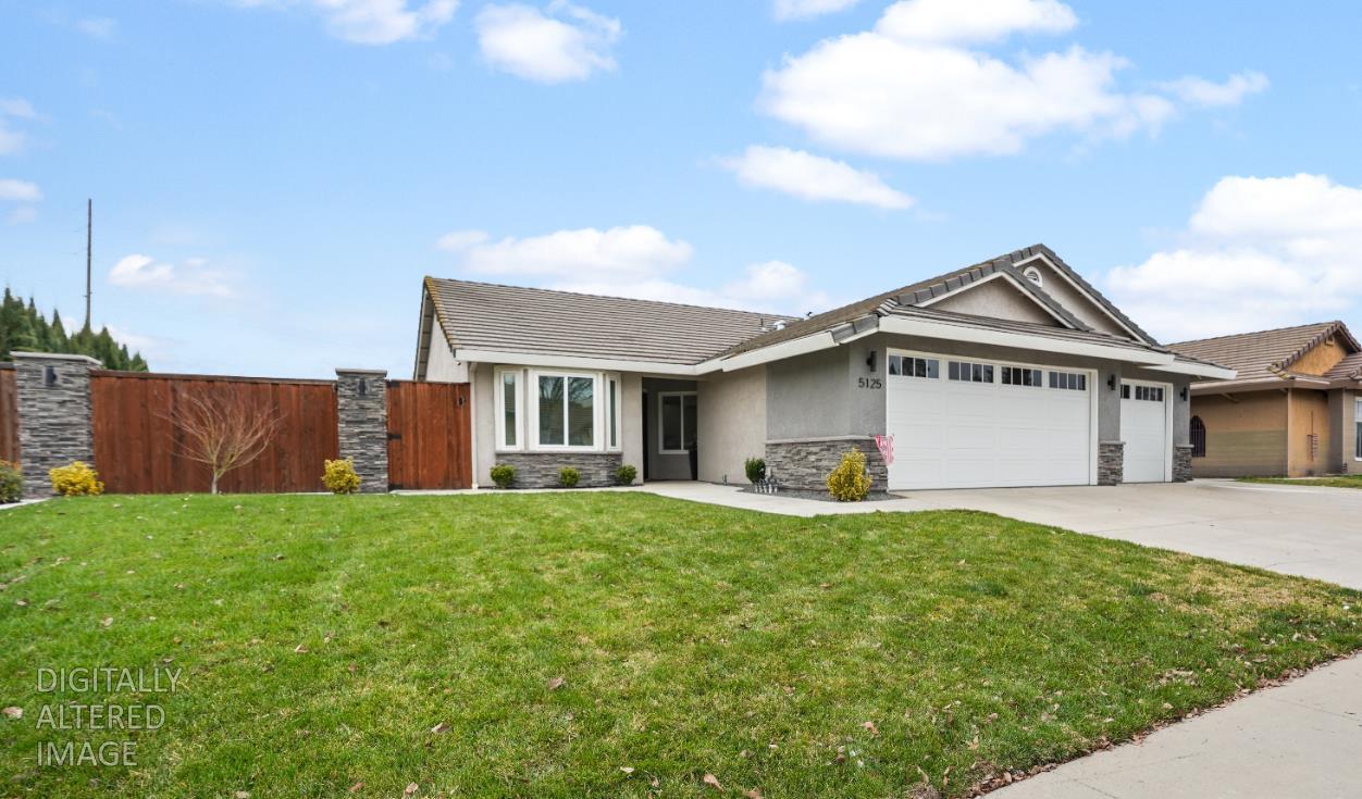 a view of a house with a yard and sitting area