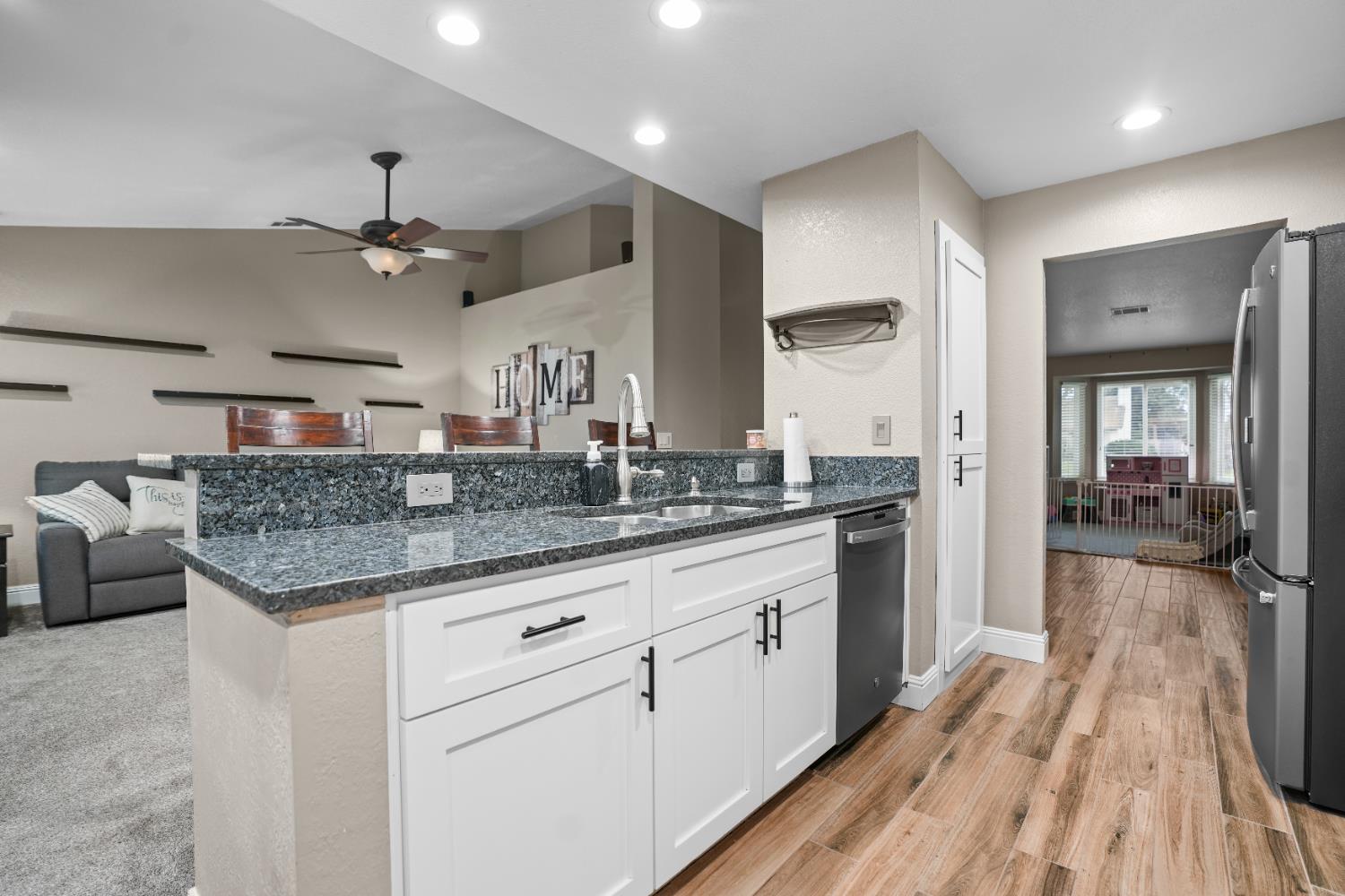 5125 Amaro Way Salida, CA 95368 - Photo 12 of 37 a bathroom with a granite countertop sink a toilet a mirror and shower