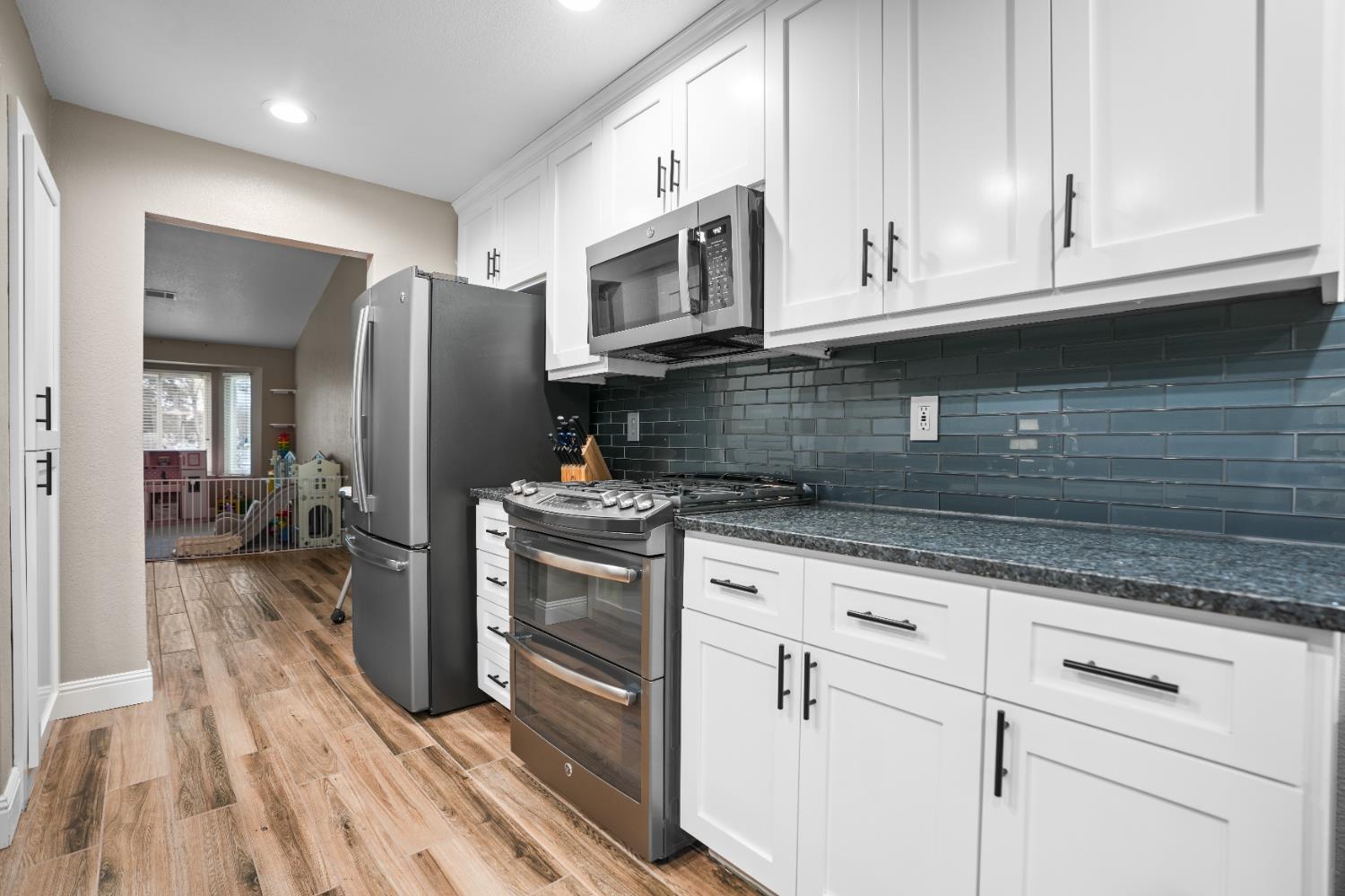 5125 Amaro Way Salida, CA 95368 - Photo 13 of 37 a kitchen with stainless steel appliances granite countertop a stove a sink and a refrigerator