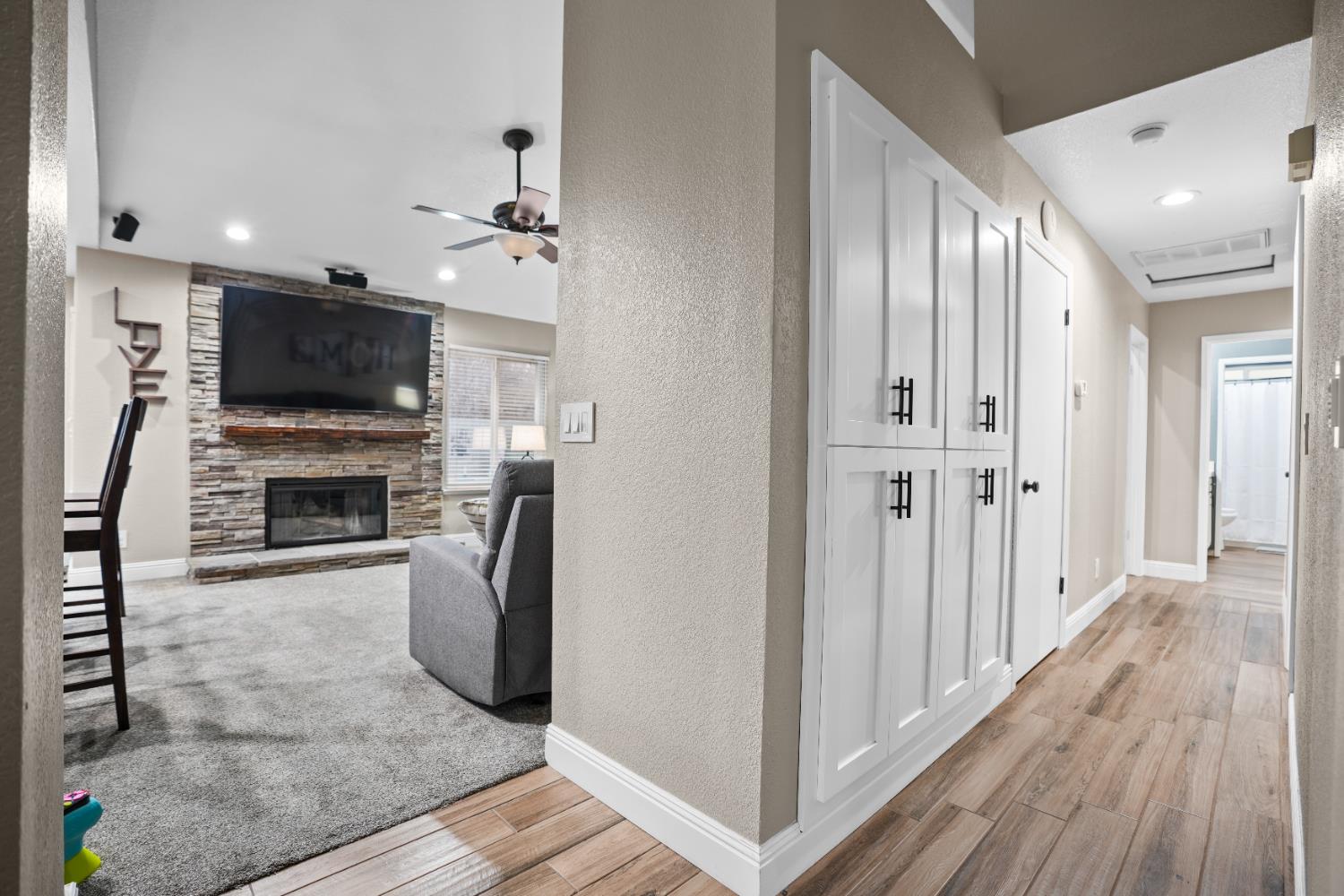 5125 Amaro Way Salida, CA 95368 - Photo 14 of 37 a view of a livingroom with a fireplace a flat screen tv and staircase